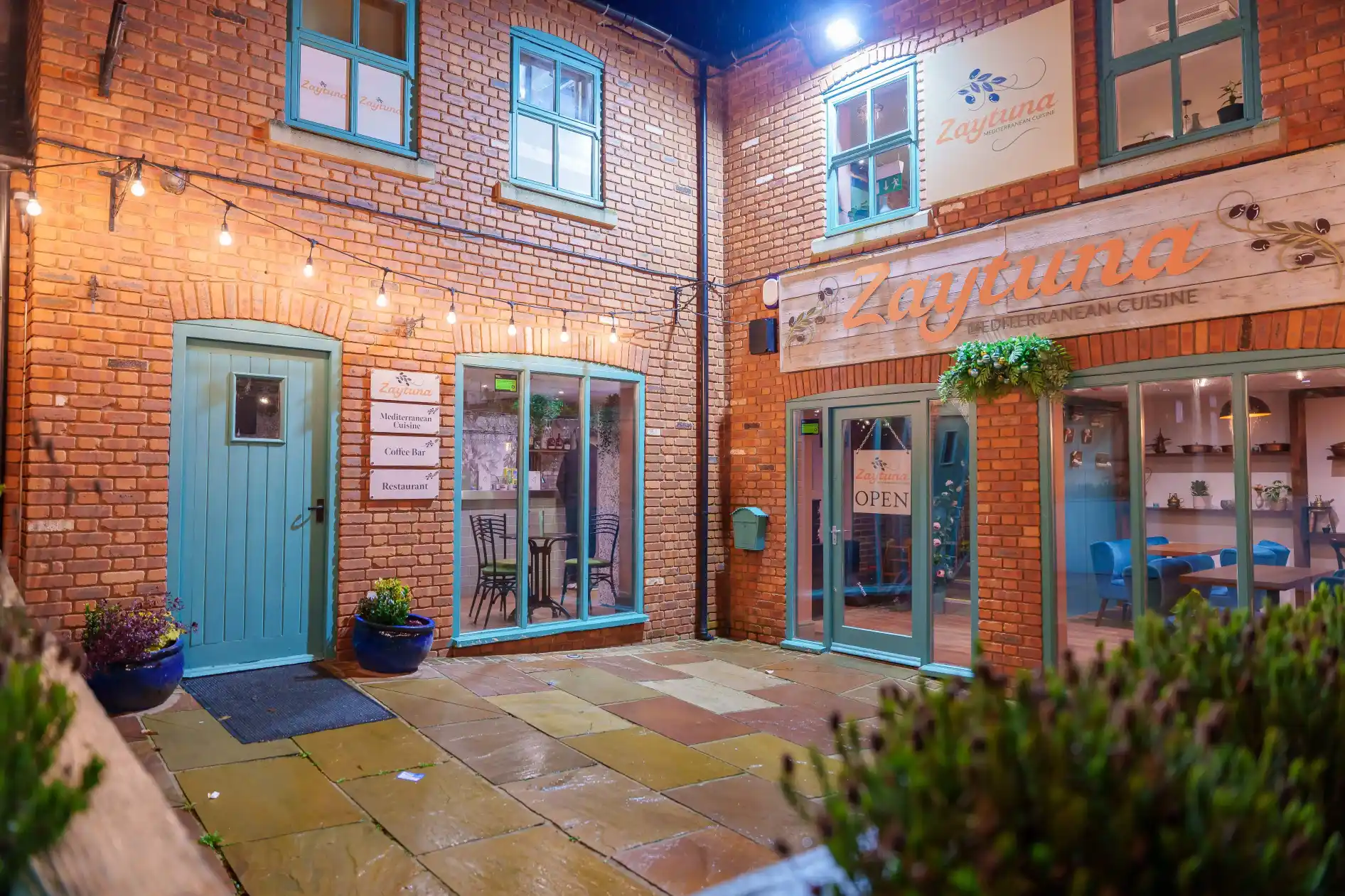 Our restaurant's facade at night, looking from straight ahead